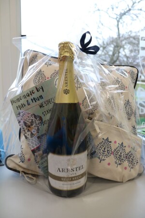 Gift Set from Homemade by Mills and Mum including a hand stamped block printed cushion and pouch with a bottle of Cava.